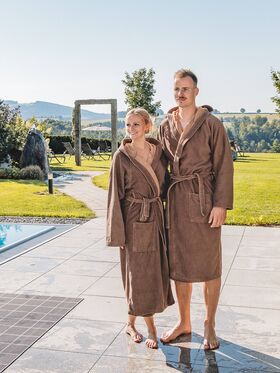 Paar im Bademantel im Wellnessgarten